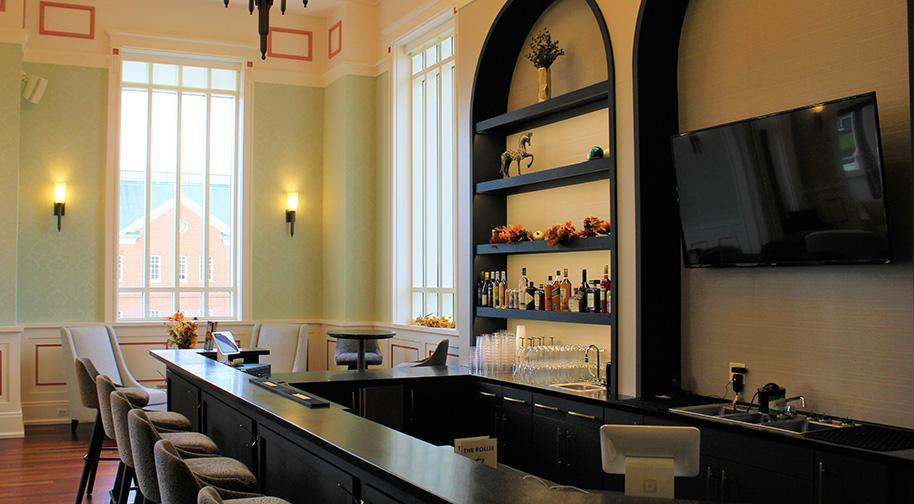 The bar in the Founders Club features elegant built-in shelving. and comfortable seating.