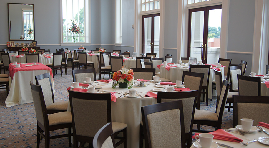 The Robert Adam Room in the Palladium filled with dining tables set for service.