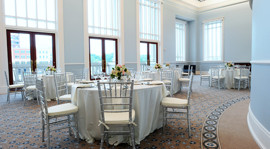 The Robert Adam Room in the Palladium filled with dining tables set for service.