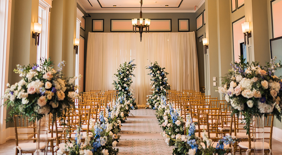 The Shiel Sexton Songbook Lounge at the top level of the Palladium is filled with chairs and floral arrangements for an elegant wedding.