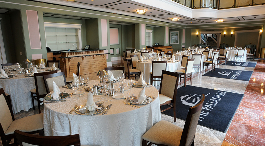 The South Lobby of the Palladium, accomodating circular dining tables for an elegant wedding dinner.