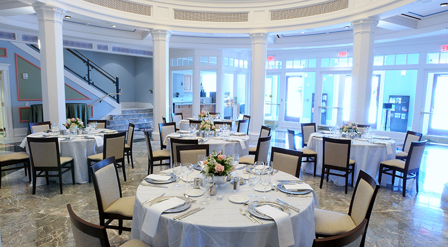 The East Lobby rotunda in the Palladium filled with tables set for dining service.