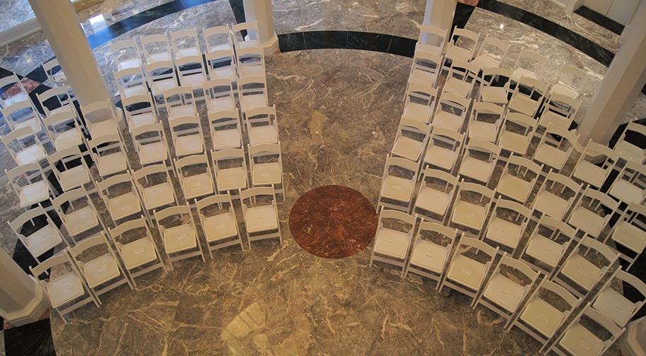 White chairs for 80 are arranged in the Palladium's East Lobby for an event.