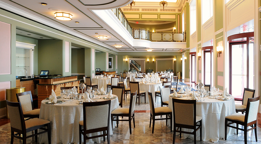 The Palladium's South Lobby filled with circular dining tables and a buffet.