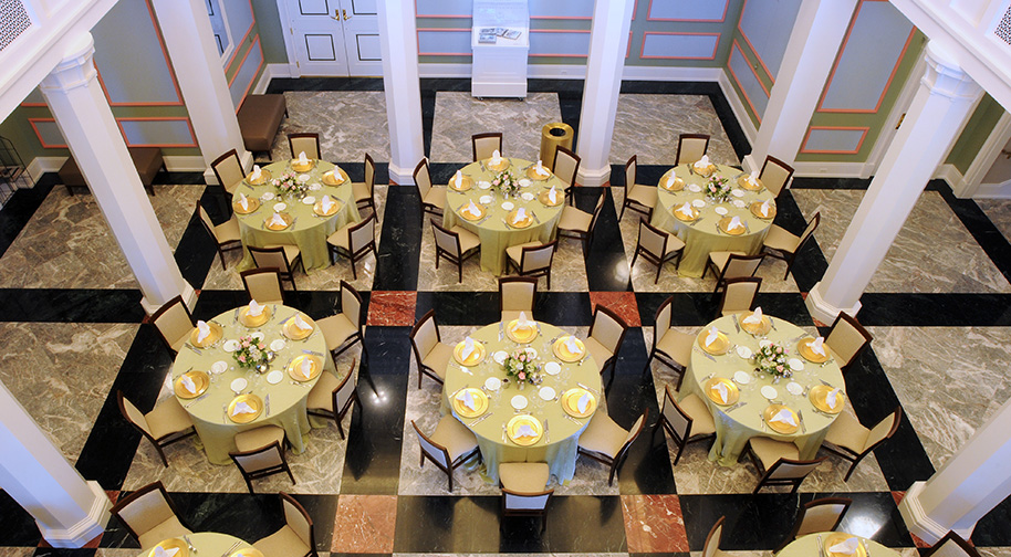 Tables arranged in the Palladium's West Lobby are set for dining service.