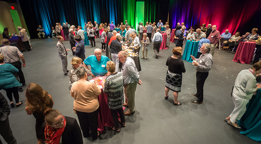 A party in the Studio Theater. Seating has been removed to accomodate cocktail tables.