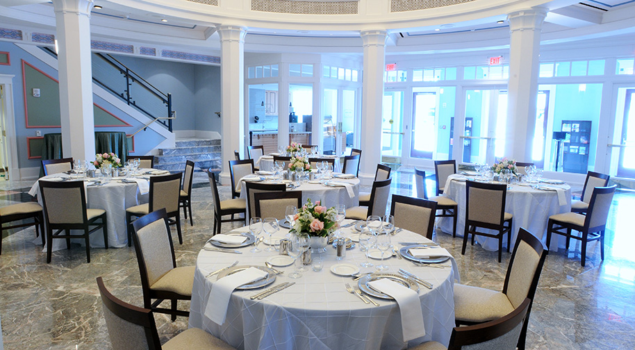 The East Lobby rotunda in the Palladium filled with tables set for dining service.