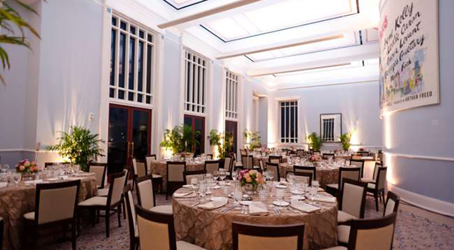 The Robert Adam Room in the Palladium filled with dining tables set for service. A large An American in Paris mural covers one wall.