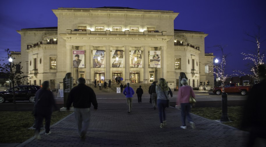 Patrons cross Carter Green to attend a performance at the Palladium.