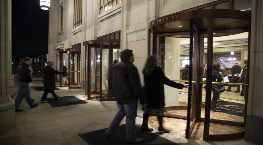 Patrons enter the revolving doors at the South entrance of the Palladium.