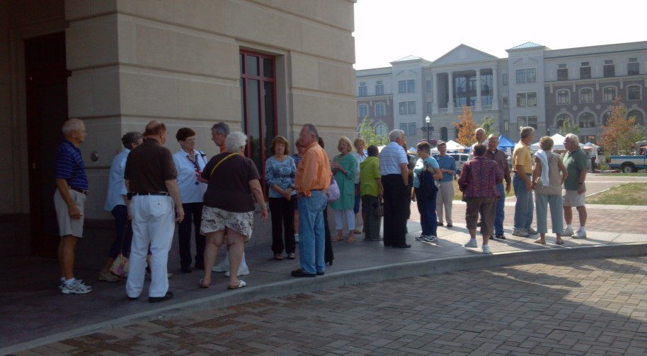 A group of patrons gather outside the West entrance of the Palladium.