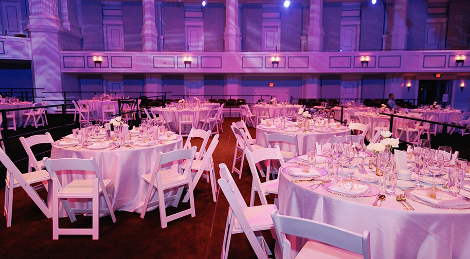 Round tables and elegant dining arrangements set on the Festival Floor in the Palladium.