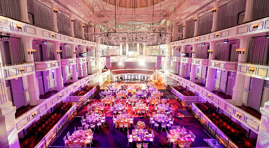 An elegant wedding in the Palladium concert hall. Festival flooring covers the main level seating to accomodate tables.