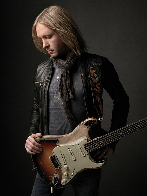 Guitarist Kenny Wayne Shepherd poses with a weathered Fender guitar