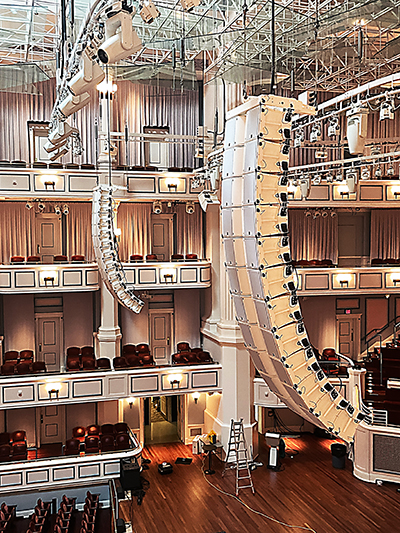 Two large speaker stacks hang over the stage of the Palladium concert hall.